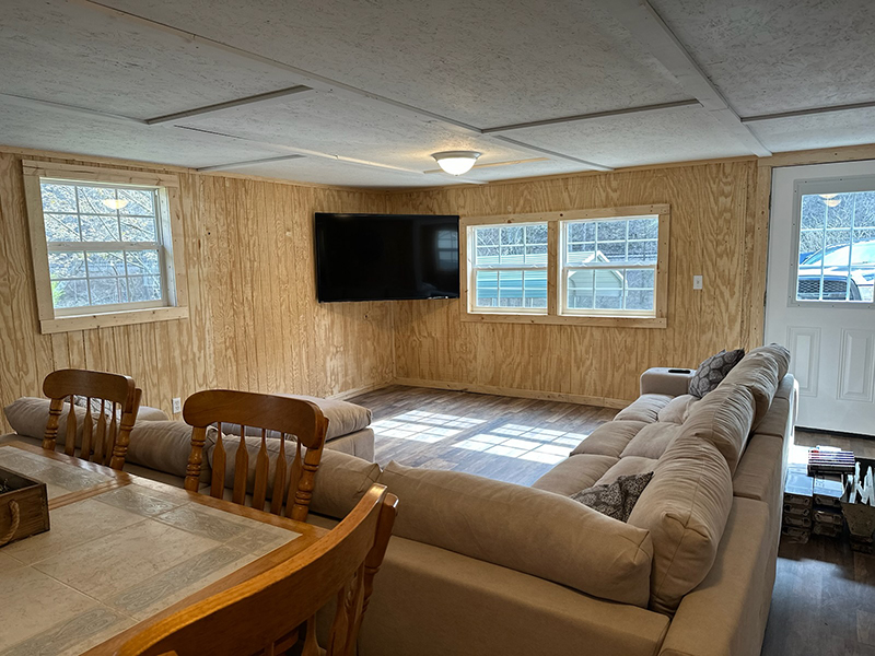 cabin living room showing the couch and TV